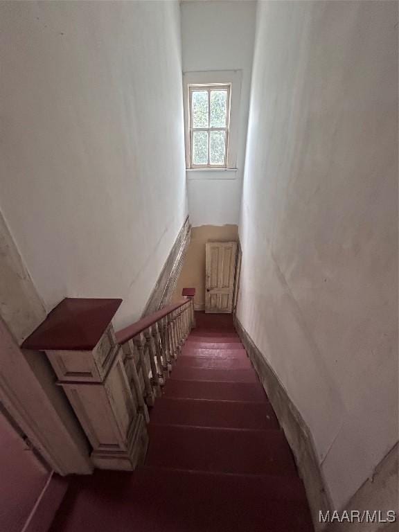 staircase featuring radiator and wood finished floors