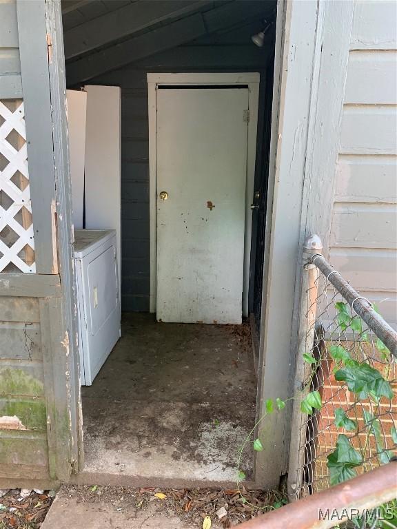 entrance to property featuring independent washer and dryer