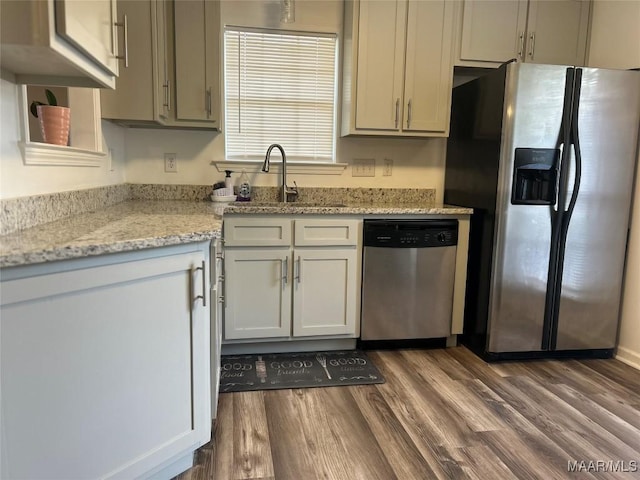 1348 Whisperwood Ct, Montgomery, AL 36117 - kitchen featuring stainless steel appliances, a sink, dark wood finished floors, and light stone countertops