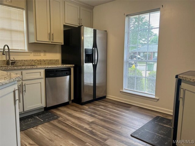 1348 Whisperwood Ct, Montgomery, AL 36117 - kitchen with appliances with stainless steel finishes, a sink, wood finished floors, and light stone countertops