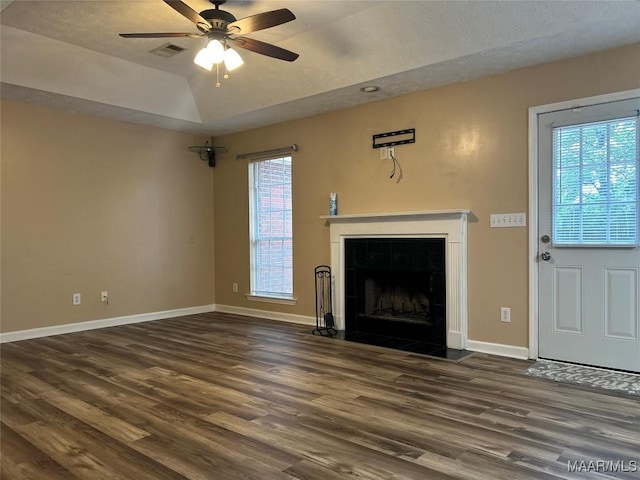1348 Whisperwood Ct, Montgomery, AL 36117 - unfurnished living room featuring dark wood-style flooring, healthy amount of natural light, a ceiling fan, baseboards, and lofted ceiling