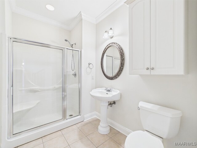 175 Rosemere Dr, Tallassee, AL 36078 - bathroom featuring crown molding, toilet, a stall shower, tile patterned floors, and baseboards