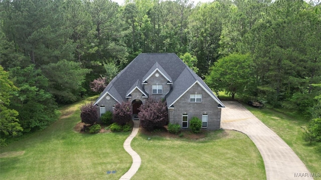 175 Rosemere Dr, Tallassee, AL 36078 - view of front of home with concrete driveway, a front yard, brick siding, a wooded view, and a shingled roof