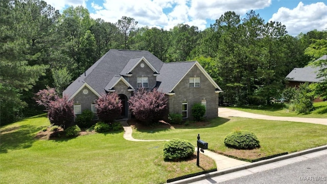 175 Rosemere Dr, Tallassee, AL 36078 - traditional home featuring a front lawn, concrete driveway, and brick siding