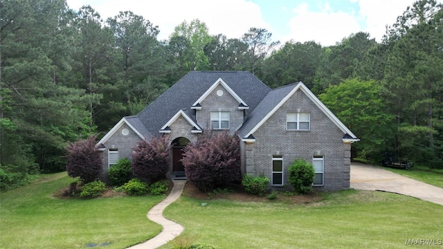 175 Rosemere Dr, Tallassee, AL 36078 - traditional-style home with brick siding, a front lawn, and a forest view