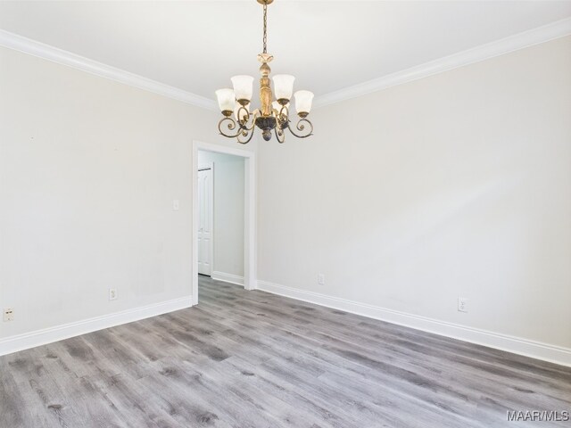 175 Rosemere Dr, Tallassee, AL 36078 - spare room with a chandelier, ornamental molding, wood finished floors, and baseboards