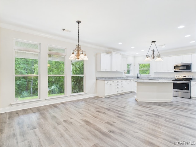 175 Rosemere Dr, Tallassee, AL 36078 - kitchen with appliances with stainless steel finishes, ornamental molding, white cabinets, light wood-type flooring, and a sink