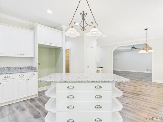 175 Rosemere Dr, Tallassee, AL 36078 - kitchen with open shelves, ornamental molding, white cabinets, light wood-type flooring, and light stone countertops