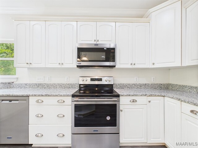 175 Rosemere Dr, Tallassee, AL 36078 - kitchen with appliances with stainless steel finishes, white cabinetry, light stone countertops, and crown molding