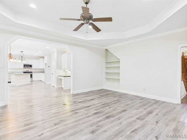 175 Rosemere Dr, Tallassee, AL 36078 - unfurnished living room featuring a tray ceiling, crown molding, light wood-type flooring, recessed lighting, and ceiling fan