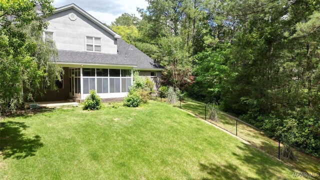 175 Rosemere Dr, Tallassee, AL 36078 - back of property featuring a sunroom and a shingled roof