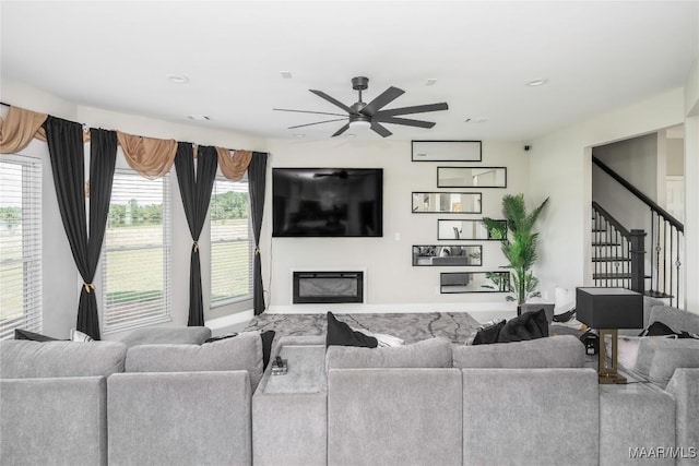 211 Oakwood Dr, Hope Hull, AL 36043 - living room with ceiling fan, a glass covered fireplace, stairs, plenty of natural light, and recessed lighting