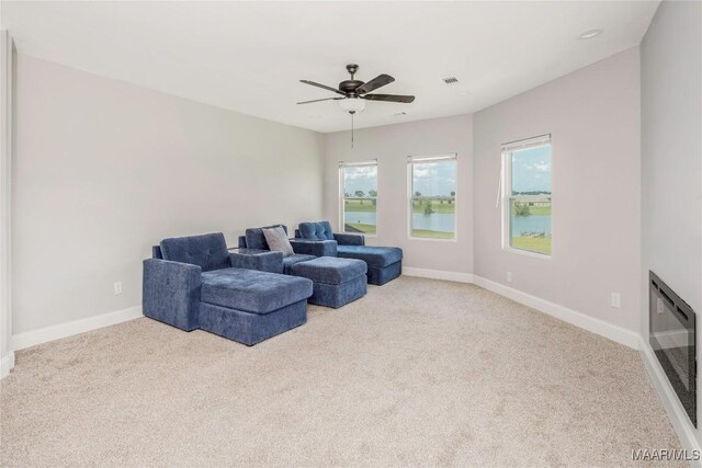 211 Oakwood Dr, Hope Hull, AL 36043 - carpeted living room with baseboards, ceiling fan, and a water view
