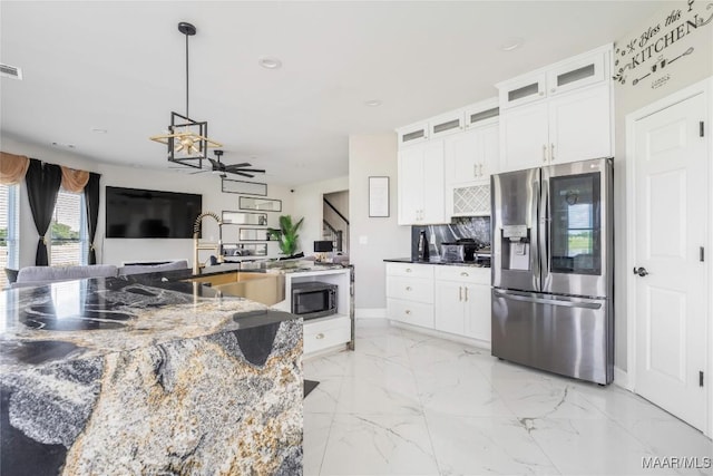 211 Oakwood Dr, Hope Hull, AL 36043 - kitchen featuring stainless steel fridge with ice dispenser, light marble finish flooring, dark stone counters, recessed lighting, and white cabinetry