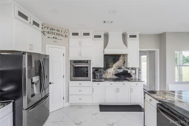 211 Oakwood Dr, Hope Hull, AL 36043 - kitchen featuring appliances with stainless steel finishes, premium range hood, dark stone counters, white cabinets, and light marble finish floors