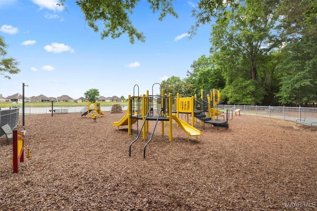 communal playground featuring fence