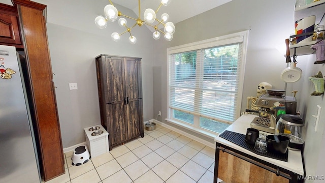 bathroom with tile patterned flooring, baseboards, a chandelier, and vaulted ceiling
