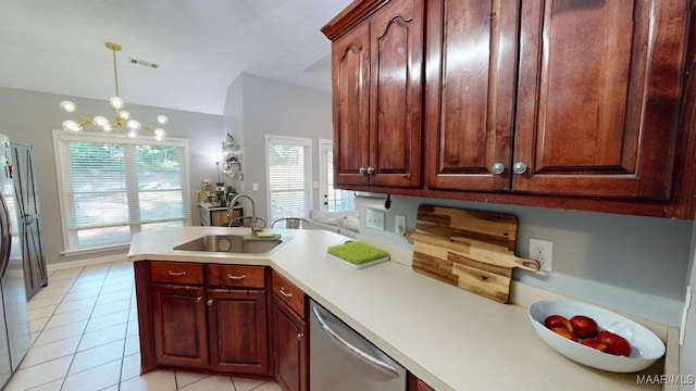 kitchen with stainless steel appliances, a sink, light tile patterned floors, and healthy amount of natural light
