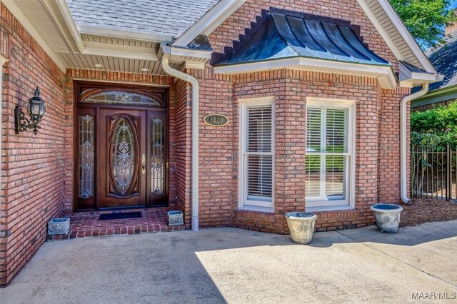 8180 Longneedle Pl, Montgomery, AL 36117 - view of exterior entry featuring brick siding and a shingled roof