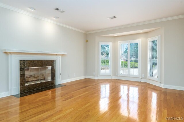8180 Longneedle Pl, Montgomery, AL 36117 - unfurnished living room with wood finished floors, baseboards, ornamental molding, and a tile fireplace