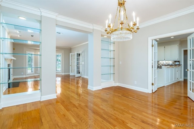 8180 Longneedle Pl, Montgomery, AL 36117 - unfurnished dining area featuring light wood finished floors, crown molding, a chandelier, and baseboards