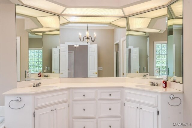 8180 Longneedle Pl, Montgomery, AL 36117 - bathroom with a chandelier and double vanity