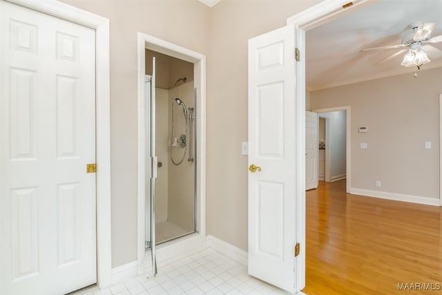 8180 Longneedle Pl, Montgomery, AL 36117 - bathroom with a ceiling fan, a stall shower, baseboards, ornamental molding, and tile patterned flooring