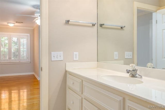8180 Longneedle Pl, Montgomery, AL 36117 - bathroom with crown molding, wood finished floors, vanity, a ceiling fan, and baseboards