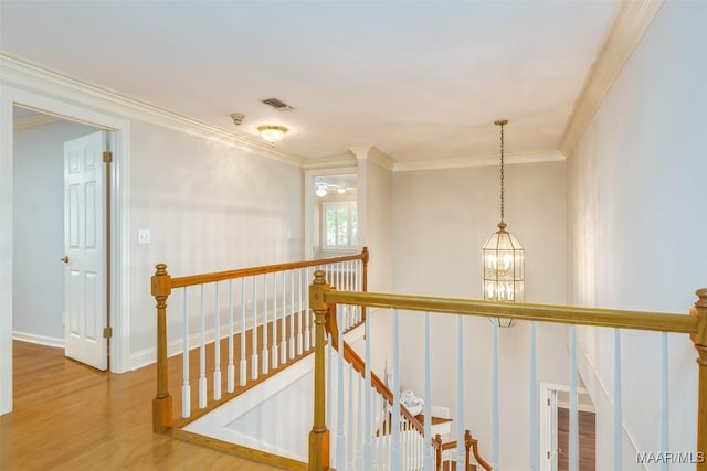 8180 Longneedle Pl, Montgomery, AL 36117 - corridor featuring an upstairs landing, wood finished floors, a chandelier, ornamental molding, and baseboards