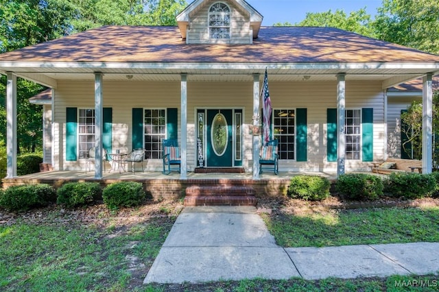 view of front facade featuring a porch and a shingled roof
