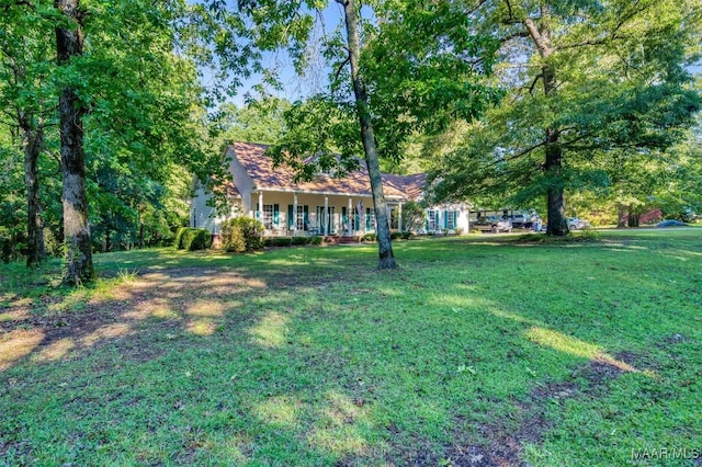 view of grassy yard with covered porch