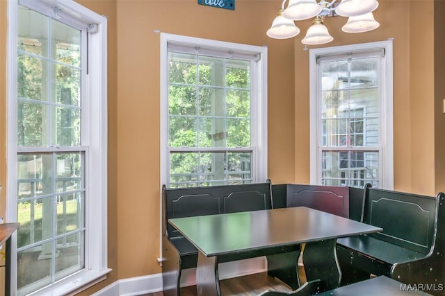 dining area with a chandelier and baseboards