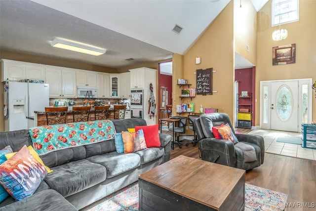living area featuring a high ceiling and light wood finished floors