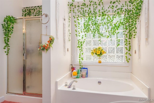 bathroom featuring a shower stall and a garden tub