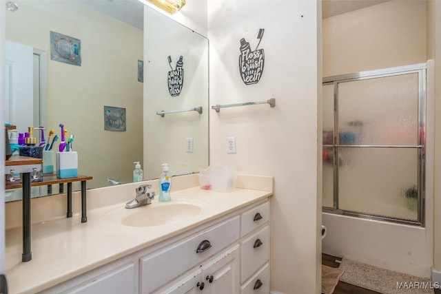full bathroom featuring vanity and bath / shower combo with glass door