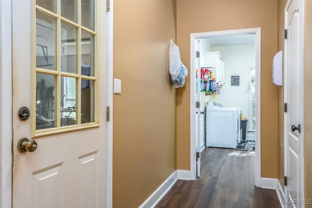 corridor with washer and clothes dryer, dark wood-style floors, and baseboards