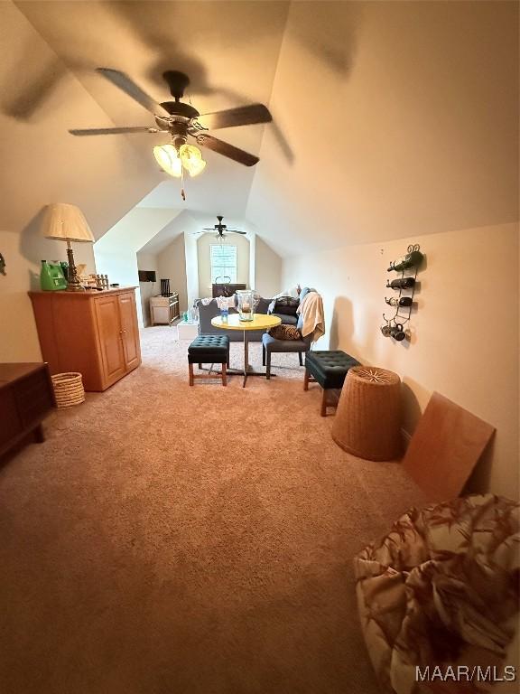 bedroom with vaulted ceiling and light colored carpet