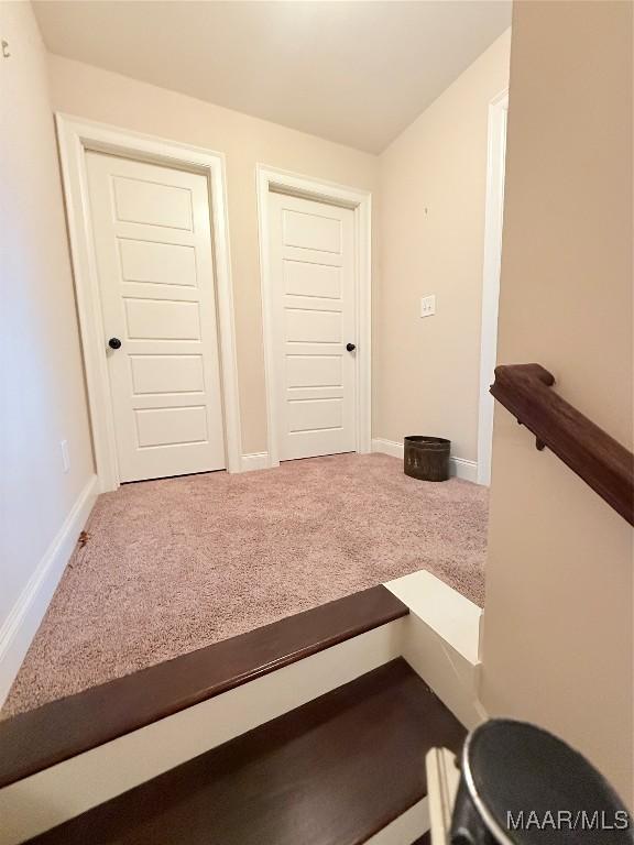 interior space featuring carpet and baseboards
