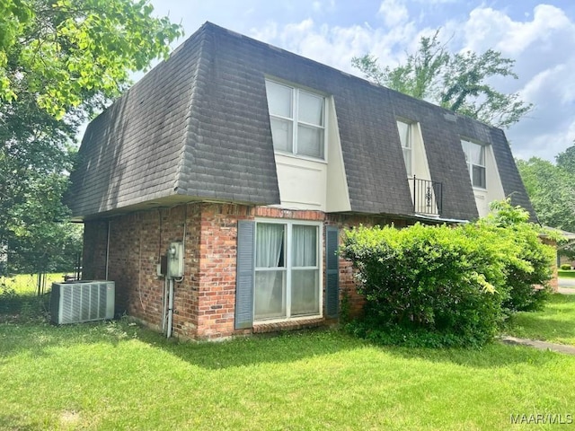 3600 Hunting Creek Rd, Montgomery, AL 36116 - rear view of property featuring mansard roof, central AC, a shingled roof, a lawn, and brick siding