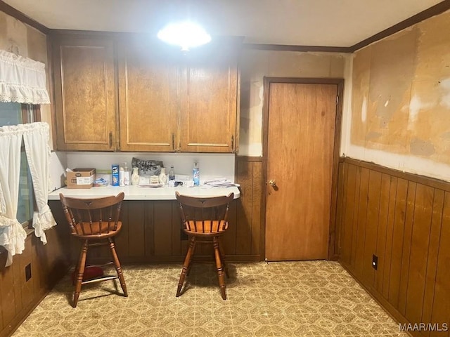 3600 Hunting Creek Rd, Montgomery, AL 36116 - dining area with a wainscoted wall, light flooring, wood walls, and crown molding