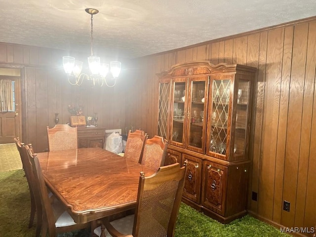 3600 Hunting Creek Rd, Montgomery, AL 36116 - dining room with a chandelier, carpet, a textured ceiling, and wood walls