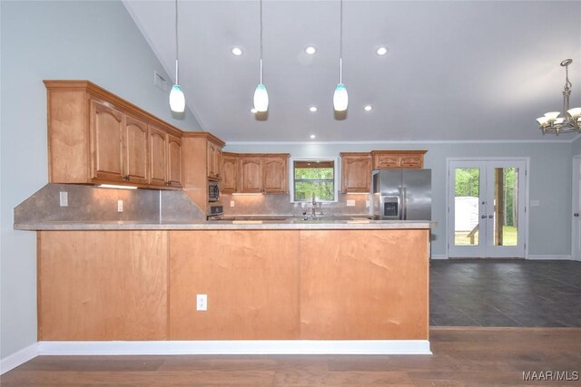 6790 Upper River Rd, Tallassee, AL 36078 - kitchen featuring stainless steel refrigerator with ice dispenser, tasteful backsplash, a peninsula, baseboards, and lofted ceiling