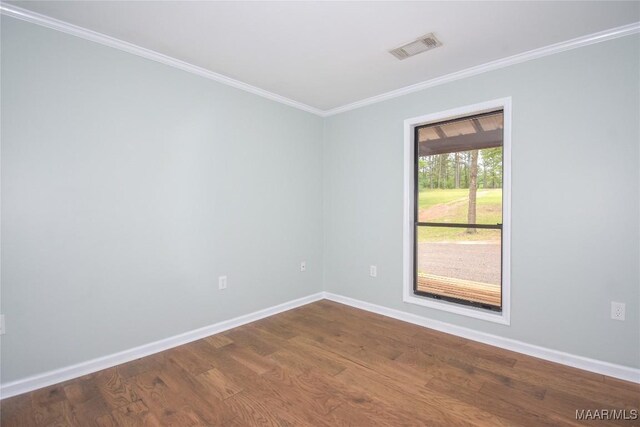 6790 Upper River Rd, Tallassee, AL 36078 - empty room featuring dark wood-type flooring, baseboards, and ornamental molding