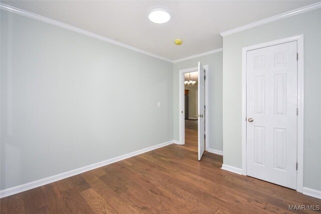 6790 Upper River Rd, Tallassee, AL 36078 - unfurnished bedroom featuring wood finished floors, ornamental molding, baseboards, and a chandelier