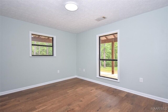 6790 Upper River Rd, Tallassee, AL 36078 - empty room with dark wood finished floors, baseboards, and a textured ceiling
