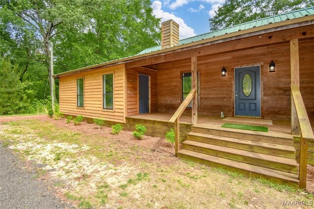 6790 Upper River Rd, Tallassee, AL 36078 - view of front of property featuring a chimney, covered porch, and metal roof