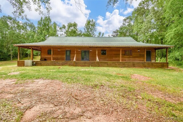 6790 Upper River Rd, Tallassee, AL 36078 - back of property featuring covered porch, cooling unit, a yard, and metal roof