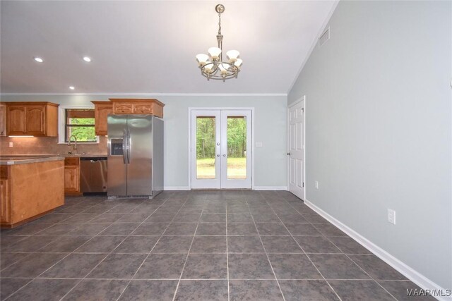 6790 Upper River Rd, Tallassee, AL 36078 - kitchen featuring stainless steel appliances, a chandelier, crown molding, dark tile patterned flooring, and a sink