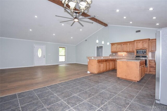 6790 Upper River Rd, Tallassee, AL 36078 - kitchen featuring stainless steel appliances, a kitchen island, open floor plan, beam ceiling, and dark tile patterned flooring