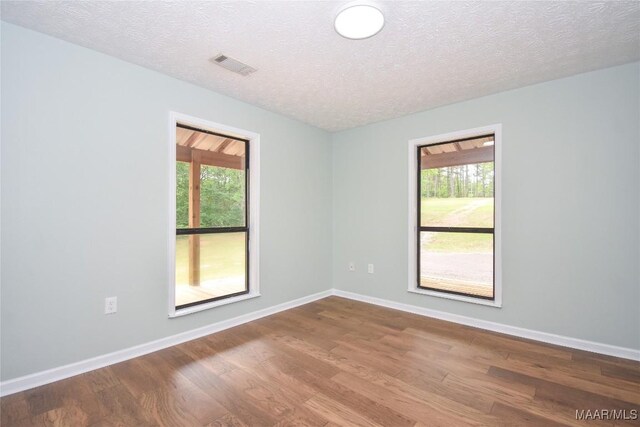 6790 Upper River Rd, Tallassee, AL 36078 - spare room with wood finished floors, baseboards, and a textured ceiling
